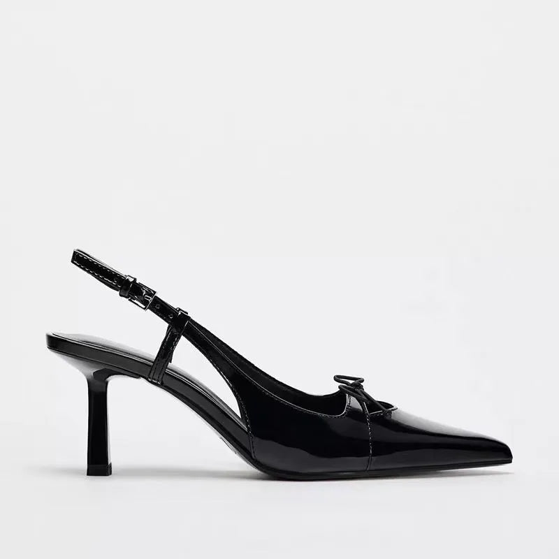 Patent leather bow with pointed tip thin heel and a shallow strap sandals